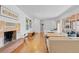 Bright living room featuring a fireplace, hardwood floors, and modern furnishings at 3198 W Amherst Ave, Denver, CO 80236
