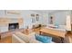 Cozy living room with a fireplace, hardwood floors, and comfortable sofas at 3198 W Amherst Ave, Denver, CO 80236