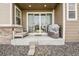 Cozy back porch with a comfortable bench, sliding glass doors, and well-maintained landscaping at 5388 Routt St # B, Arvada, CO 80002