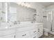 Bright bathroom features double sinks with sleek hardware and a glass-enclosed shower at 5388 Routt St # B, Arvada, CO 80002
