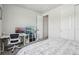 Modern bedroom includes a computer and monitor, white shelving unit, and white doors at 5388 Routt St # B, Arvada, CO 80002