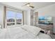 Bright bedroom with a fluffy bed, ceiling fan, and scenic views at 5388 Routt St # B, Arvada, CO 80002