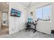Bright bedroom has a desk, television mounted on the wall, closet and gray carpeting at 5388 Routt St # B, Arvada, CO 80002