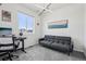 A bright bedroom includes a desk, modern lighting, and a sofa for relaxing at 5388 Routt St # B, Arvada, CO 80002