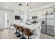 Bright kitchen with white cabinets, stainless appliances, and a large island with seating at 5388 Routt St # B, Arvada, CO 80002