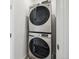 Laundry area features a stacked washer and dryer in a compact space at 5388 Routt St # B, Arvada, CO 80002