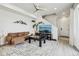 Cozy living room with modern ceiling fan, decorative rug, comfortable brown sofa, and mountain wall art at 5388 Routt St # B, Arvada, CO 80002