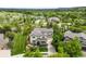 Aerial view of home with mature trees and green lawn at 6032 Umber St, Arvada, CO 80403