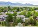 Scenic aerial shot showcases a home surrounded by mature trees in a peaceful neighborhood at 6032 Umber St, Arvada, CO 80403