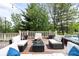 Back deck furnished with black wicker patio seating, glass coffee table, and potted plants at 6032 Umber St, Arvada, CO 80403