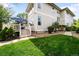 Backyard view of upper deck with stairs and lawn at 6032 Umber St, Arvada, CO 80403