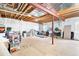 Unfinished basement space, ready for customization, with exposed beams and utilities at 6032 Umber St, Arvada, CO 80403