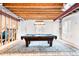 Finished basement with billiards table, drop lighting, and a large area rug at 6032 Umber St, Arvada, CO 80403