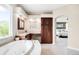 This bathroom features a soaking tub, make up vanity and access to the main bedroom at 6032 Umber St, Arvada, CO 80403