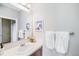 This bathroom features a single sink, tile backsplash and towel rack at 6032 Umber St, Arvada, CO 80403