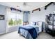 This bedroom features a window with natural light, blue comforter and sports decor at 6032 Umber St, Arvada, CO 80403