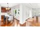 Dining area adjacent to the kitchen with elegant lighting and access to the outdoor deck, perfect for entertaining at 6032 Umber St, Arvada, CO 80403