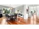 Spacious dining room with hardwood floors, chandelier, and large windows at 6032 Umber St, Arvada, CO 80403