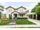 Charming two-story home featuring a well-manicured front yard, inviting entrance, and an attached garage with a pergola-covered driveway at 6032 Umber St, Arvada, CO 80403