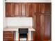 Functional built-in home office with dark wood cabinets, drawers and dedicated workspace for productivity and organization at 6032 Umber St, Arvada, CO 80403