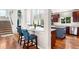 Open kitchen with breakfast bar, stainless steel appliances, and hardwood flooring at 6032 Umber St, Arvada, CO 80403
