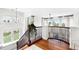 Upper landing with wood floors and view to the living room with large windows at 6032 Umber St, Arvada, CO 80403