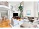 Bright living room featuring hardwood floors, high ceilings, and comfortable furniture at 6032 Umber St, Arvada, CO 80403