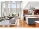 Open floor plan features a modern kitchen, adjacent to a living area with soaring ceilings and large windows at 6032 Umber St, Arvada, CO 80403