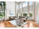 Bright living room boasts soaring ceilings, expansive windows, and hardwood floors at 6032 Umber St, Arvada, CO 80403