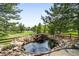 Scenic outdoor pond with rock features and landscaping at 6032 Umber St, Arvada, CO 80403