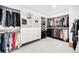 This walk-in closet has ample storage with shelving, drawers and hanger bars at 6032 Umber St, Arvada, CO 80403