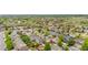 Expansive aerial view showcases a neighborhood with green trees, well-spaced houses, and a serene pond nearby at 13664 Linden Ct, Thornton, CO 80602
