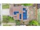 Aerial view of roof with solar panels and a well-maintained yard with landscaping, greenery, and gravel at 13664 Linden Ct, Thornton, CO 80602
