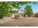 Spacious backyard with a patio, hot tub, picnic table, and mature trees, perfect for outdoor living at 13664 Linden Ct, Thornton, CO 80602