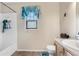A compact bathroom featuring a tiled shower, a white toilet, and a neutral-toned vanity at 13664 Linden Ct, Thornton, CO 80602