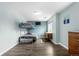 Cozy bedroom featuring wood floors, a bunk bed, and a built-in TV at 13664 Linden Ct, Thornton, CO 80602