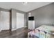 Cozy bedroom with wood floors, a flamingo print, and a white wrought iron bed frame at 13664 Linden Ct, Thornton, CO 80602