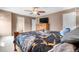 Comfortable bedroom featuring ceiling fan, dresser, and a black, white and gold comforter at 13664 Linden Ct, Thornton, CO 80602