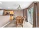 Dining area with a wooden table, seating for four, and natural light from sliding glass doors at 13664 Linden Ct, Thornton, CO 80602