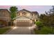 Charming two-story home with a two-car garage, stone accents, and manicured landscaping at 13664 Linden Ct, Thornton, CO 80602