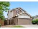Inviting home exterior with a two-car garage, stone accents, and well-maintained front yard at 13664 Linden Ct, Thornton, CO 80602