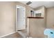 Well-lit hallway with neutral walls, carpeted floor, and a view of adjacent rooms at 13664 Linden Ct, Thornton, CO 80602