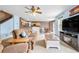 Comfortable living room with a sofa, ceiling fan, and an open view of the dining area at 13664 Linden Ct, Thornton, CO 80602