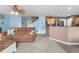 Cozy living room with plush seating, neutral carpet, and open access to the kitchen area at 13664 Linden Ct, Thornton, CO 80602
