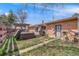 Brick home with backyard featuring a hot tub, patio, grill, and yard at 3200 Eastman Ave, Boulder, CO 80305