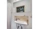 Bathroom features a wall-mounted sink and a large mirror for a bright and airy space at 3200 Eastman Ave, Boulder, CO 80305