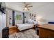 Cozy bedroom featuring wood floors, ceiling fan, and updated window frames at 3200 Eastman Ave, Boulder, CO 80305