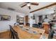 Open dining room featuring a long wooden table, wooden ceiling beam and access to the kitchen at 3200 Eastman Ave, Boulder, CO 80305
