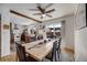Open dining area showcasing a large wooden table, ceiling fan and easy access to the kitchen and outdoor patio at 3200 Eastman Ave, Boulder, CO 80305