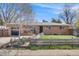 Charming brick home with a well-manicured front yard and a quaint wooden fence at 3200 Eastman Ave, Boulder, CO 80305